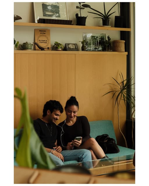 Two people sharing a quiet moment on a cafe bench