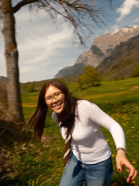 A joyful motion-blurred portrait in a mountain meadow