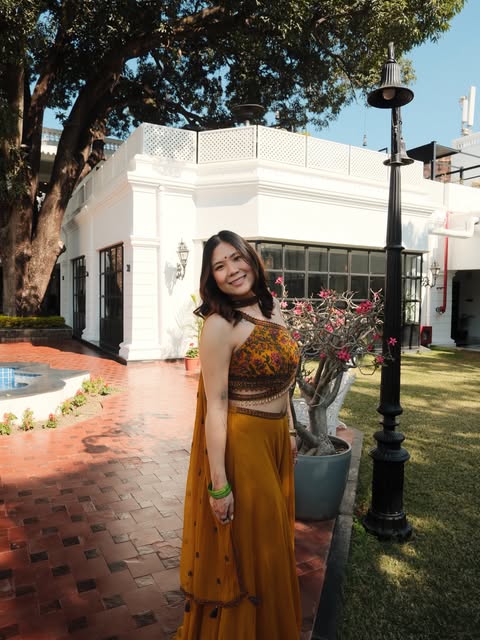 A warm street portrait beside flowering trees