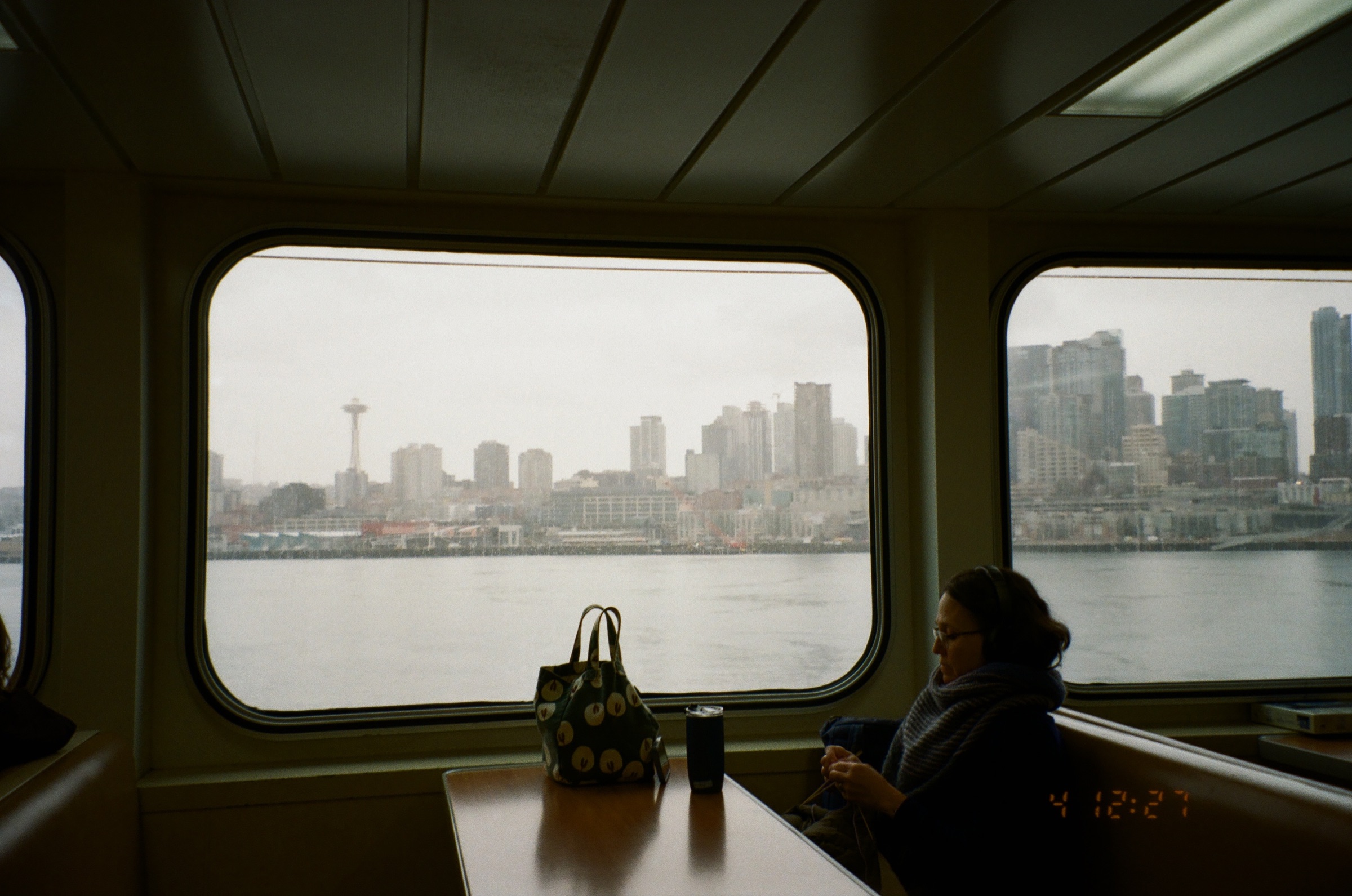 A quiet passenger framed by a Washington State Ferry window