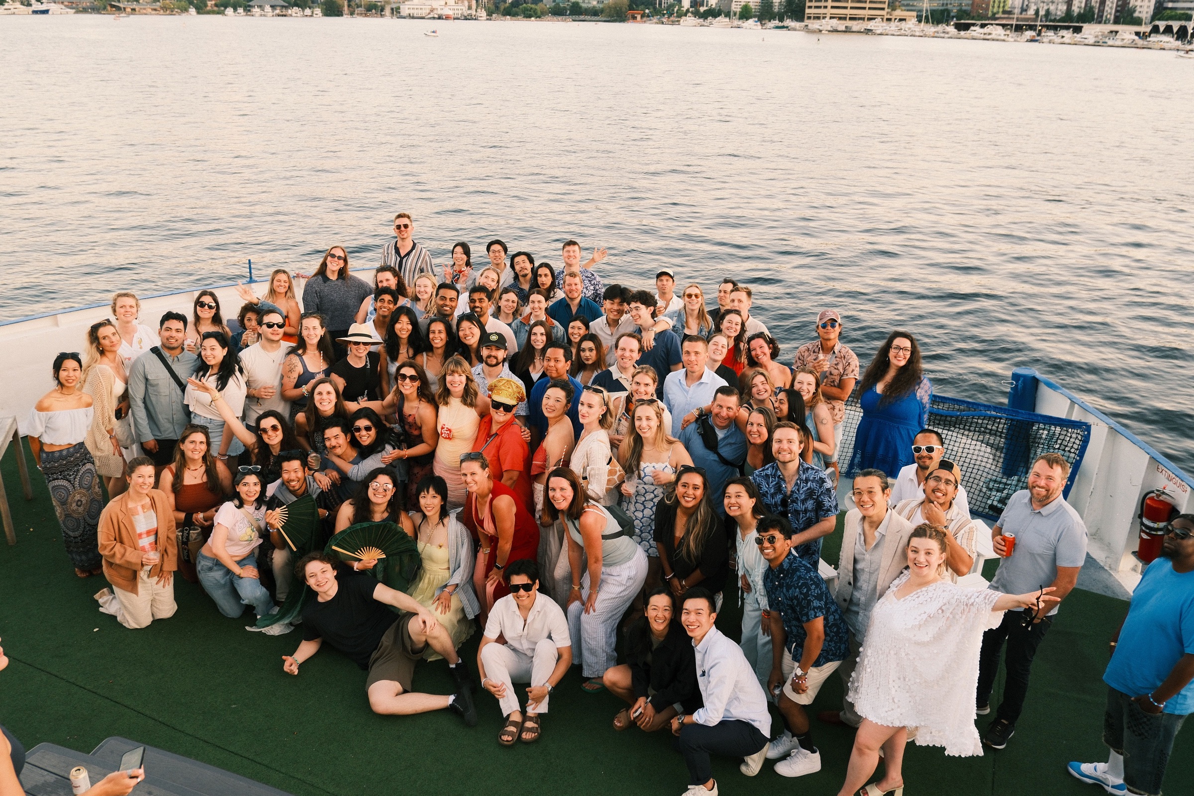A large group gathered together at the water's edge