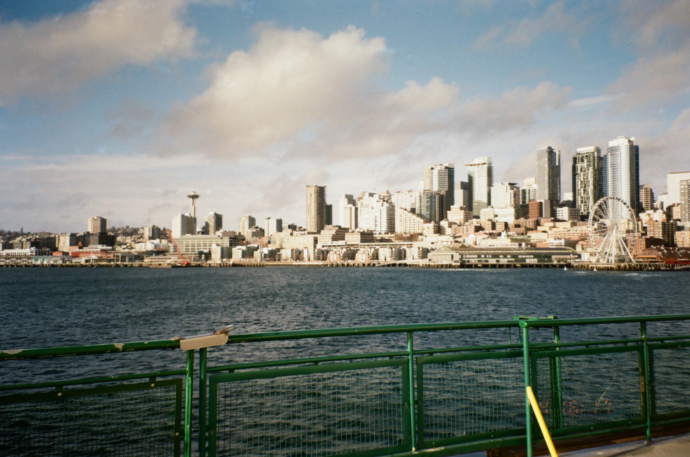 Seattle skyline seen from the water under soft clouds