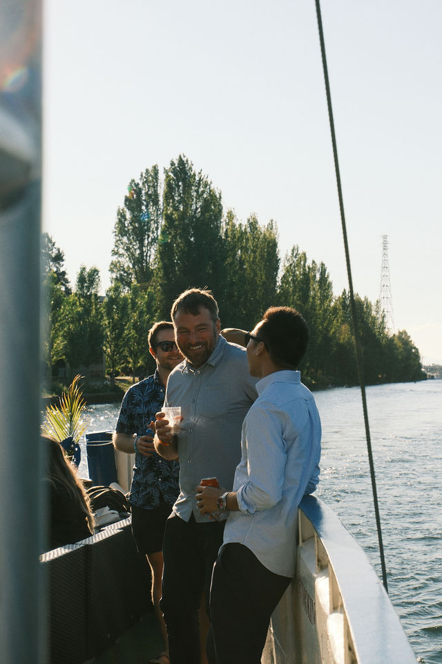 Two friends talking at sunset on the water